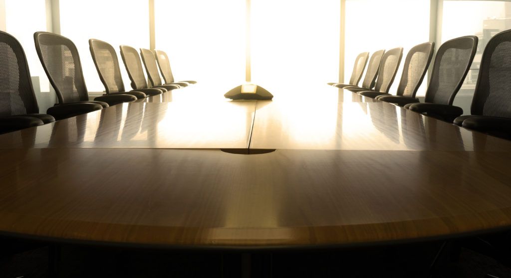 Conference table lined with chairs